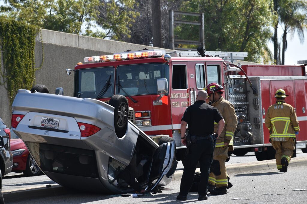 Uber and Lyft accident scene with damaged cars on the road