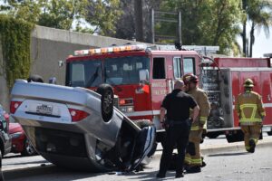 Uber and Lyft accident scene with damaged cars on the road