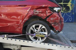 Rear-end collision scene showing two damaged vehicles while drivers document the crash for an insurance claim